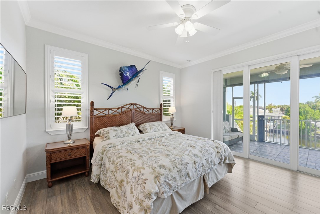 12304 Boat Shell Drive Matlacha Isles, FL 33991 - Photo 19 of 47 a bedroom with a bed and a chandelier