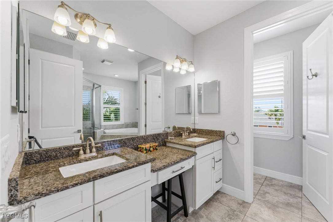 12304 Boat Shell Drive Matlacha Isles, FL 33991 - Photo 20 of 47 a bathroom with double sink and a mirror