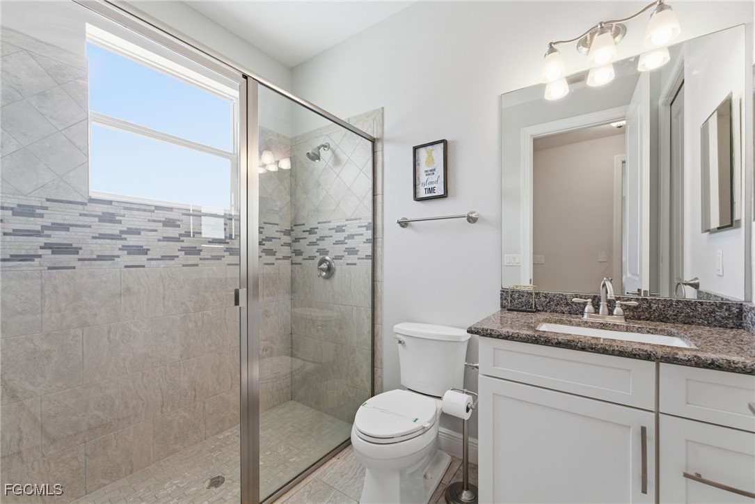 12304 Boat Shell Drive Matlacha Isles, FL 33991 - Photo 26 of 47 a bathroom with a granite countertop sink toilet and shower