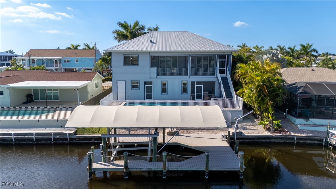 12304 Boat Shell Drive Matlacha Isles, FL 33991 - Photo 42 of 47 a view of a swimming pool with a table and chairs