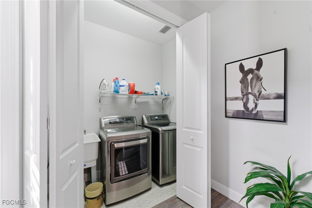 12304 Boat Shell Drive Matlacha Isles, FL 33991 - Photo 7 of 47 a view of a storage and utility room with washer and dryer