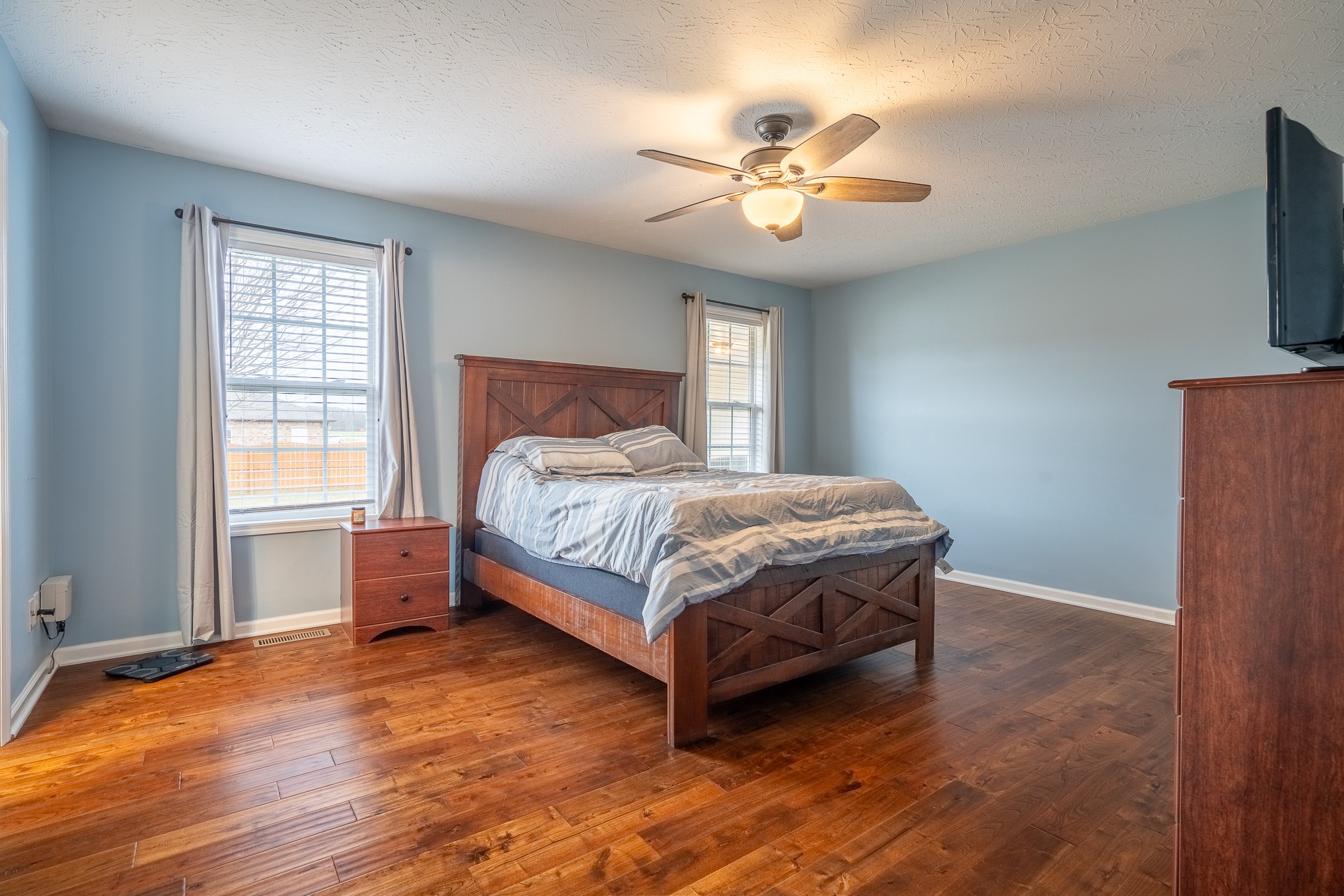 110 Kitty Meyer Lane Loretto, TN 38469 - Photo 21 of 27 a bedroom with a bed and a chandelier
