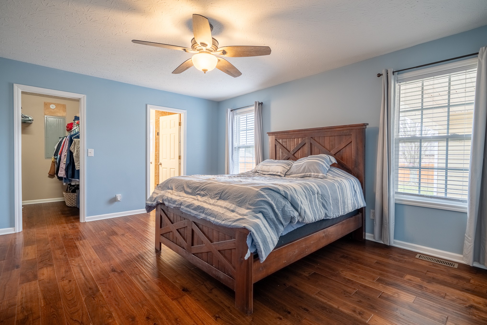 110 Kitty Meyer Lane Loretto, TN 38469 - Photo 22 of 27 a bedroom with a bed and a chandelier
