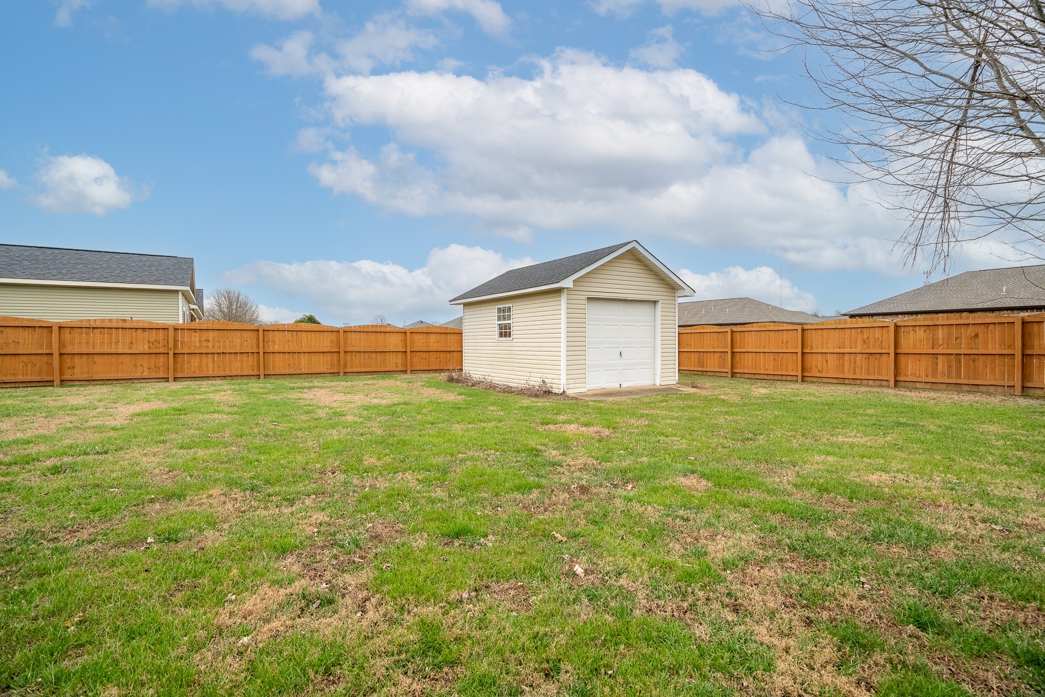 110 Kitty Meyer Lane Loretto, TN 38469 - Photo 6 of 27 a view of a big yard with an empty space and wooden fence