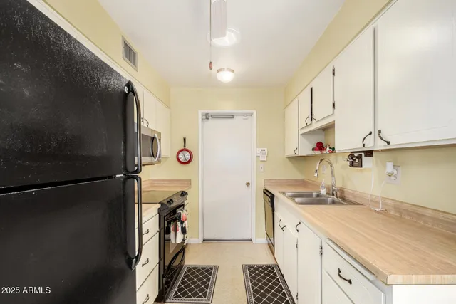 a kitchen with a refrigerator and a stove