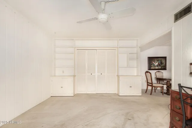 an empty room with windows and closet