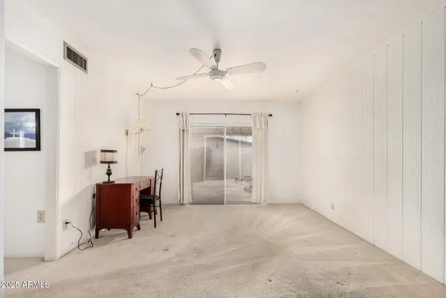 a view of a livingroom with furniture and a ceiling fan