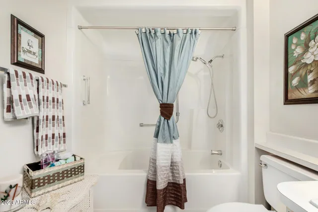 a bathroom with a shower a toilet and a sink