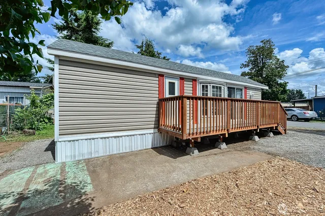 a view of a house with a yard and deck