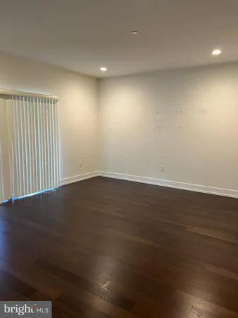 an empty room with wooden floor
