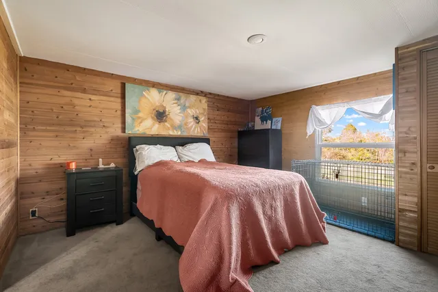 a bedroom with a bed and window