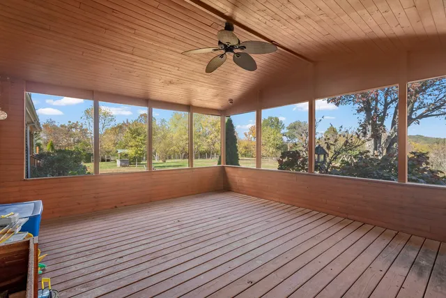 a view of a house with a yard covered in snow