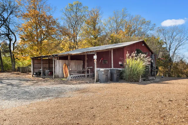 a front view of a house with a tree