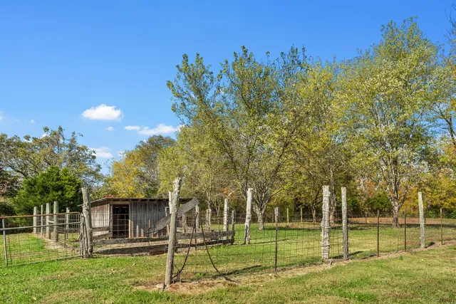 a view of a balcony with floor to ceiling windows yard and a patio