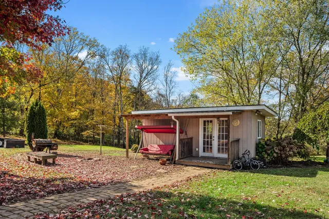 a backyard of a house with table and chairs