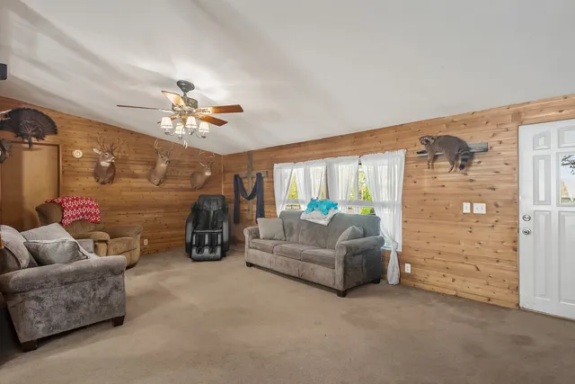 a living room with furniture and a chandelier