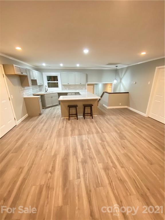 536 Fairview Road Marion, NC 28752 - Photo 2 of 34 a view of a kitchen with kitchen island a sink wooden floor and a refrigerator