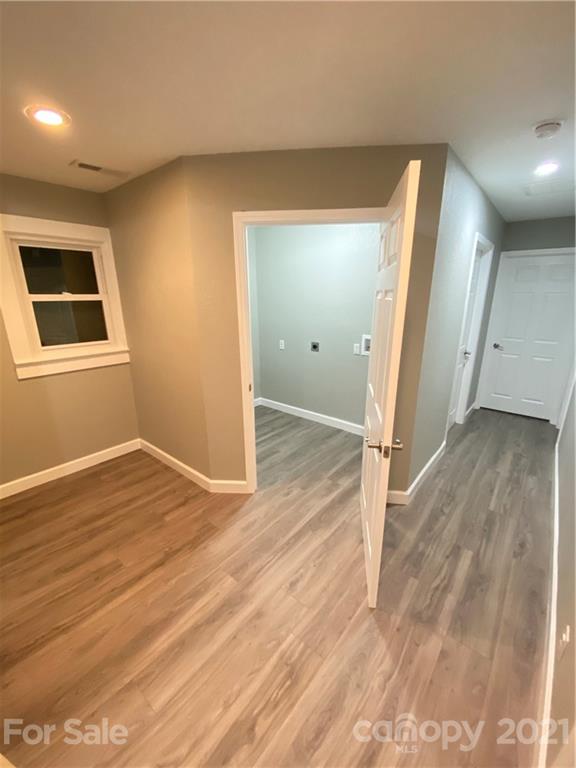 536 Fairview Road Marion, NC 28752 - Photo 21 of 34 an empty room with wooden floor and entrance