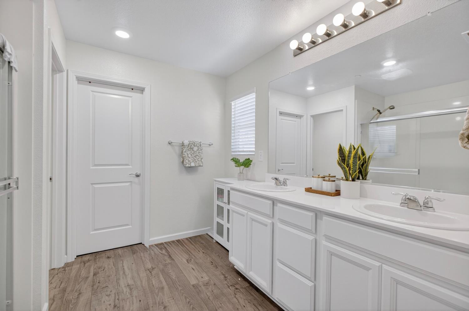 11786 Socrates Way Rancho Cordova, CA 95742 - Photo 23 of 48 a bathroom with a double vanity sink and a mirror