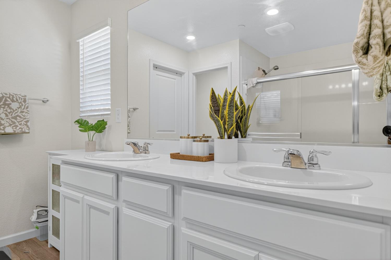 11786 Socrates Way Rancho Cordova, CA 95742 - Photo 24 of 48 a bathroom with a double vanity sink and a mirror