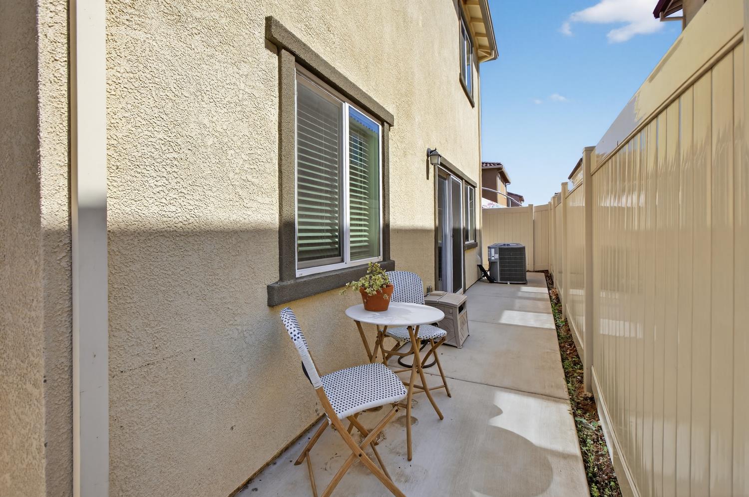 11786 Socrates Way Rancho Cordova, CA 95742 - Photo 26 of 48 a patio with table and chairs and potted plants