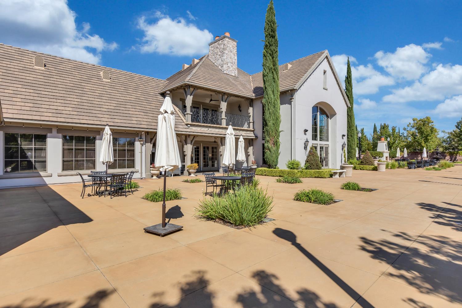 11786 Socrates Way Rancho Cordova, CA 95742 - Photo 38 of 48 a view of a patio with couches and table and chairs under an umbrella