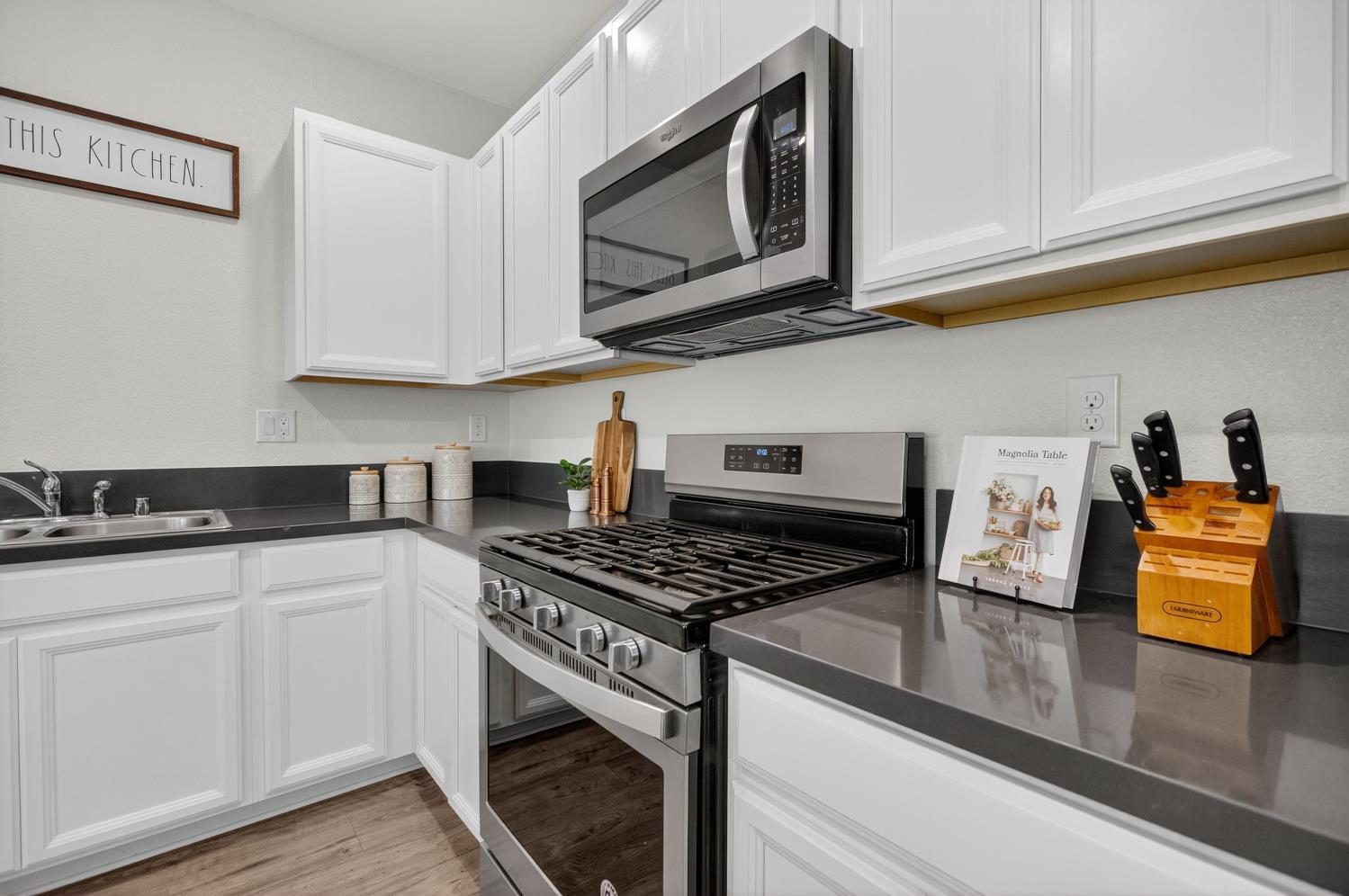 11786 Socrates Way Rancho Cordova, CA 95742 - Photo 6 of 48 a kitchen with stainless steel appliances granite countertop a sink and a stove