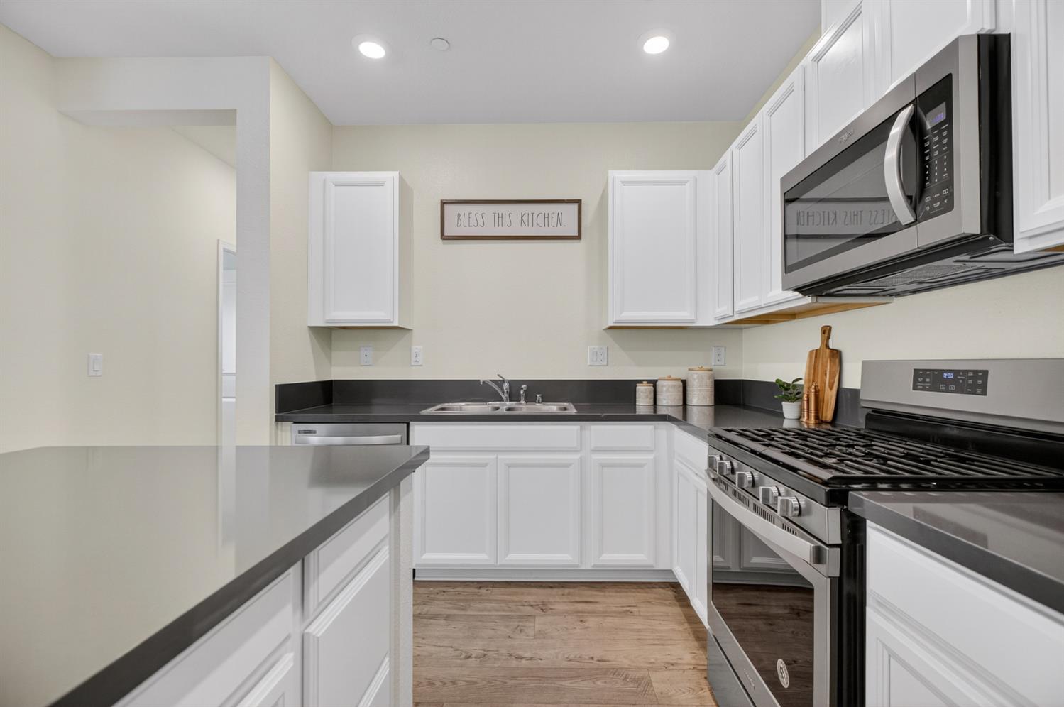 11786 Socrates Way Rancho Cordova, CA 95742 - Photo 7 of 48 a kitchen with stainless steel appliances granite countertop a stove and a microwave