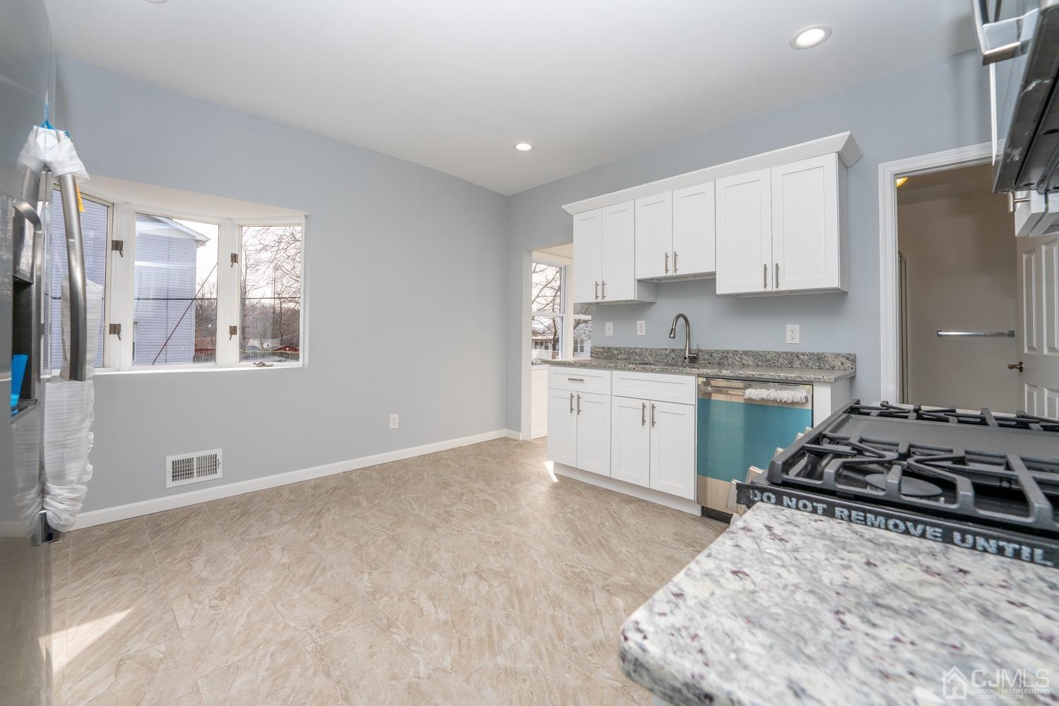 42 Meadow Road Edison, NJ 08817 - Photo 11 of 35 a kitchen with stainless steel appliances granite countertop a stove a sink and a refrigerator
