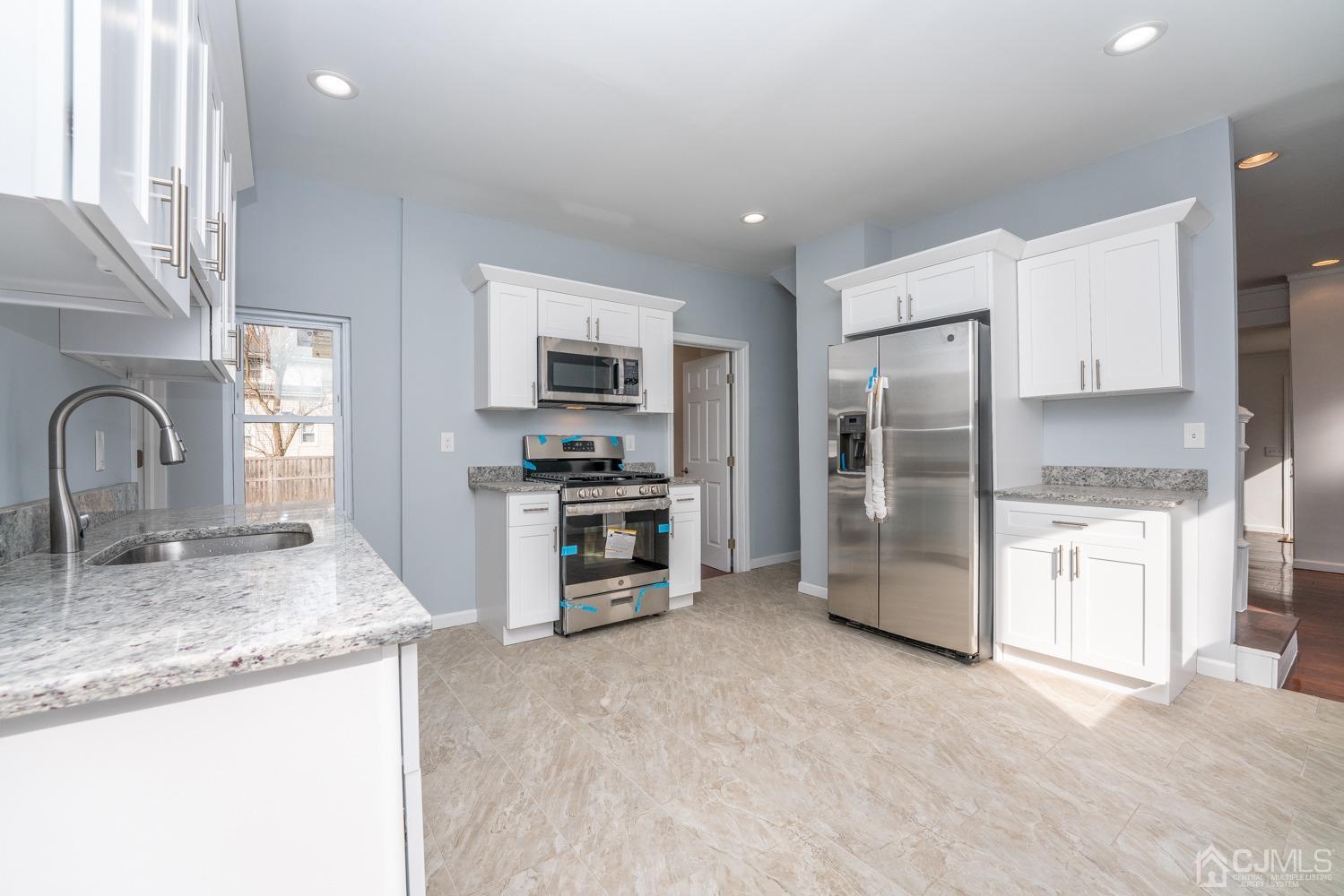 42 Meadow Road Edison, NJ 08817 - Photo 12 of 35 a kitchen with stainless steel appliances granite countertop a refrigerator and a sink