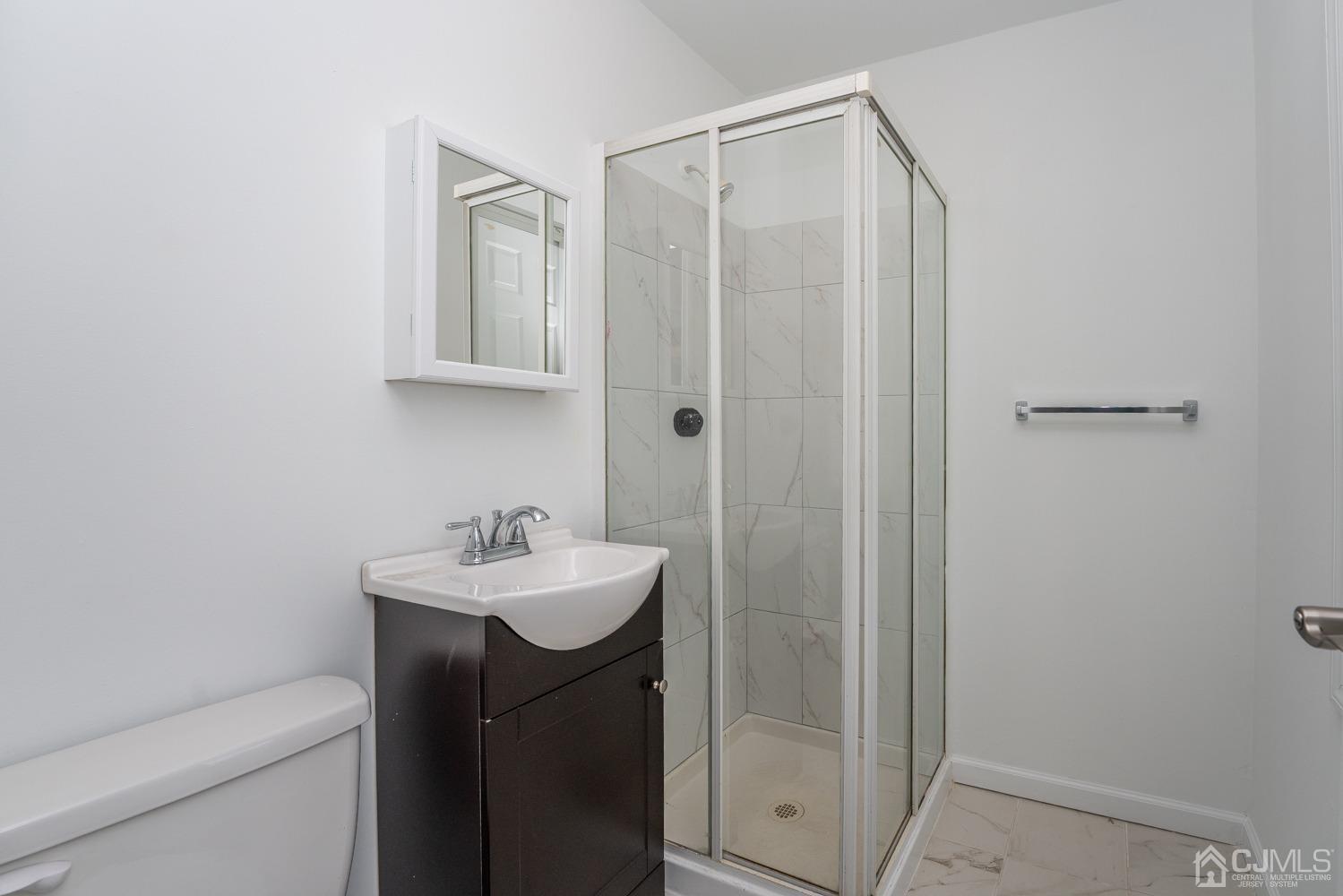 42 Meadow Road Edison, NJ 08817 - Photo 13 of 35 a bathroom with a sink a toilet and a mirror