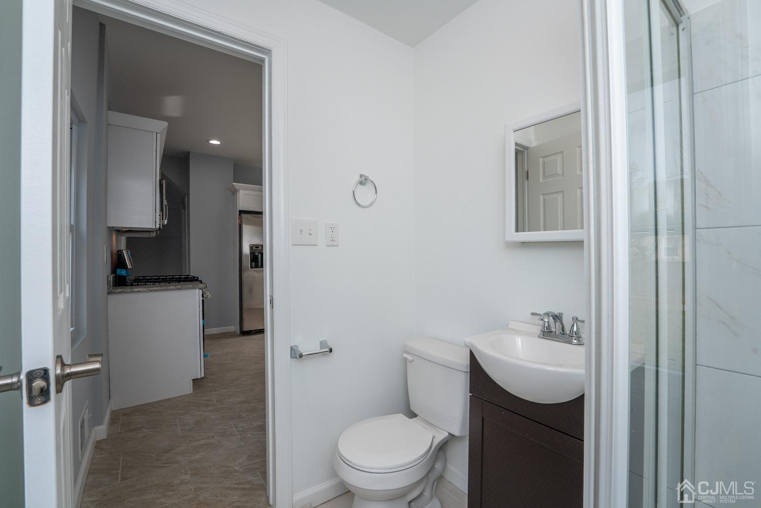 42 Meadow Road Edison, NJ 08817 - Photo 14 of 35 a bathroom with a toilet sink and shower