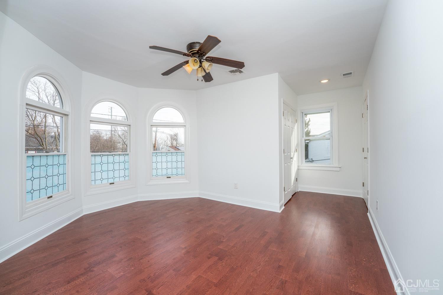 42 Meadow Road Edison, NJ 08817 - Photo 18 of 35 a view of an empty room with a window and wooden floor
