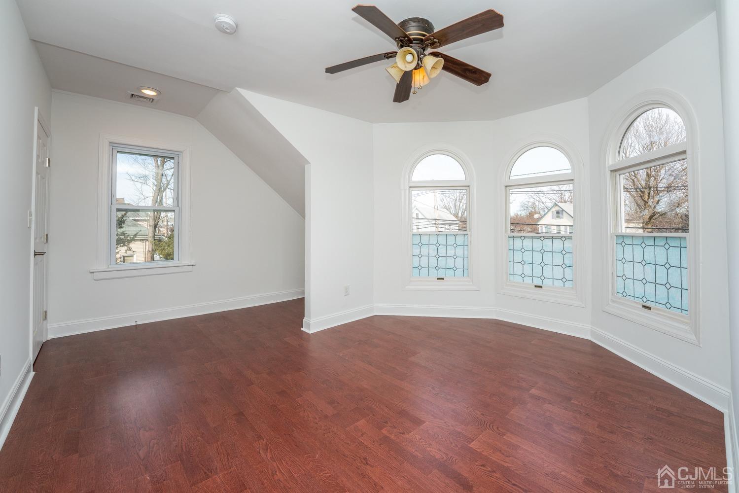 42 Meadow Road Edison, NJ 08817 - Photo 19 of 35 a view of an empty room with a window and wooden floor