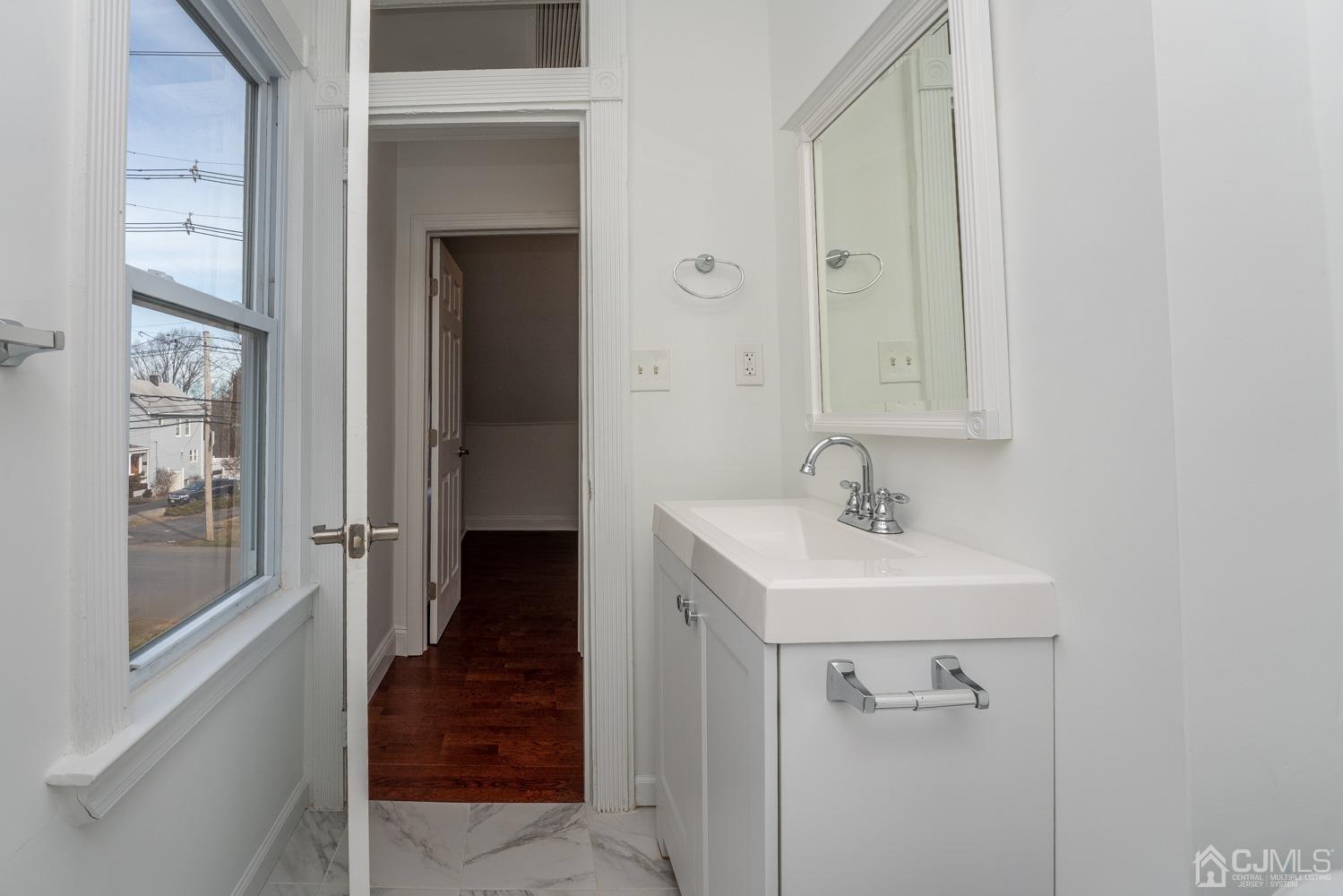 42 Meadow Road Edison, NJ 08817 - Photo 21 of 35 a bathroom with a sink a toilet and shower