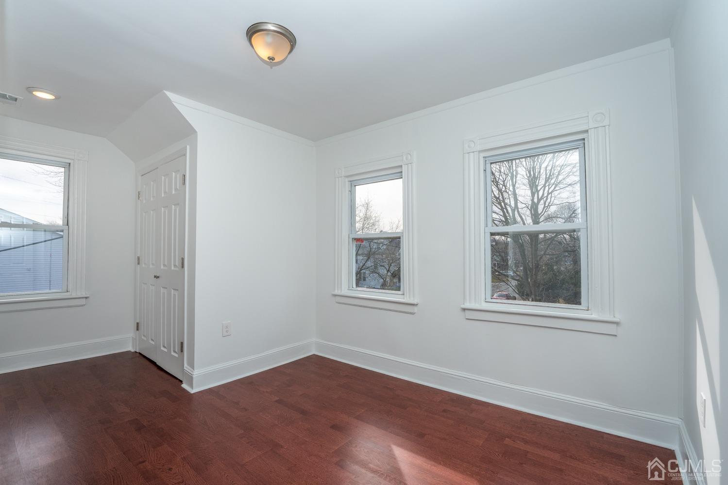 42 Meadow Road Edison, NJ 08817 - Photo 23 of 35 an empty room with wooden floor and windows