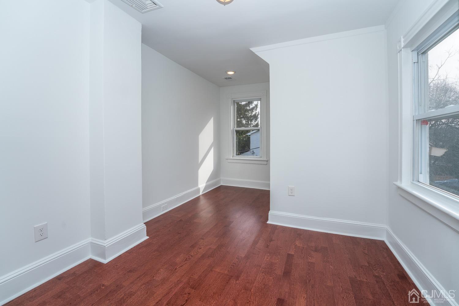 42 Meadow Road Edison, NJ 08817 - Photo 24 of 35 an empty room with wooden floor and windows