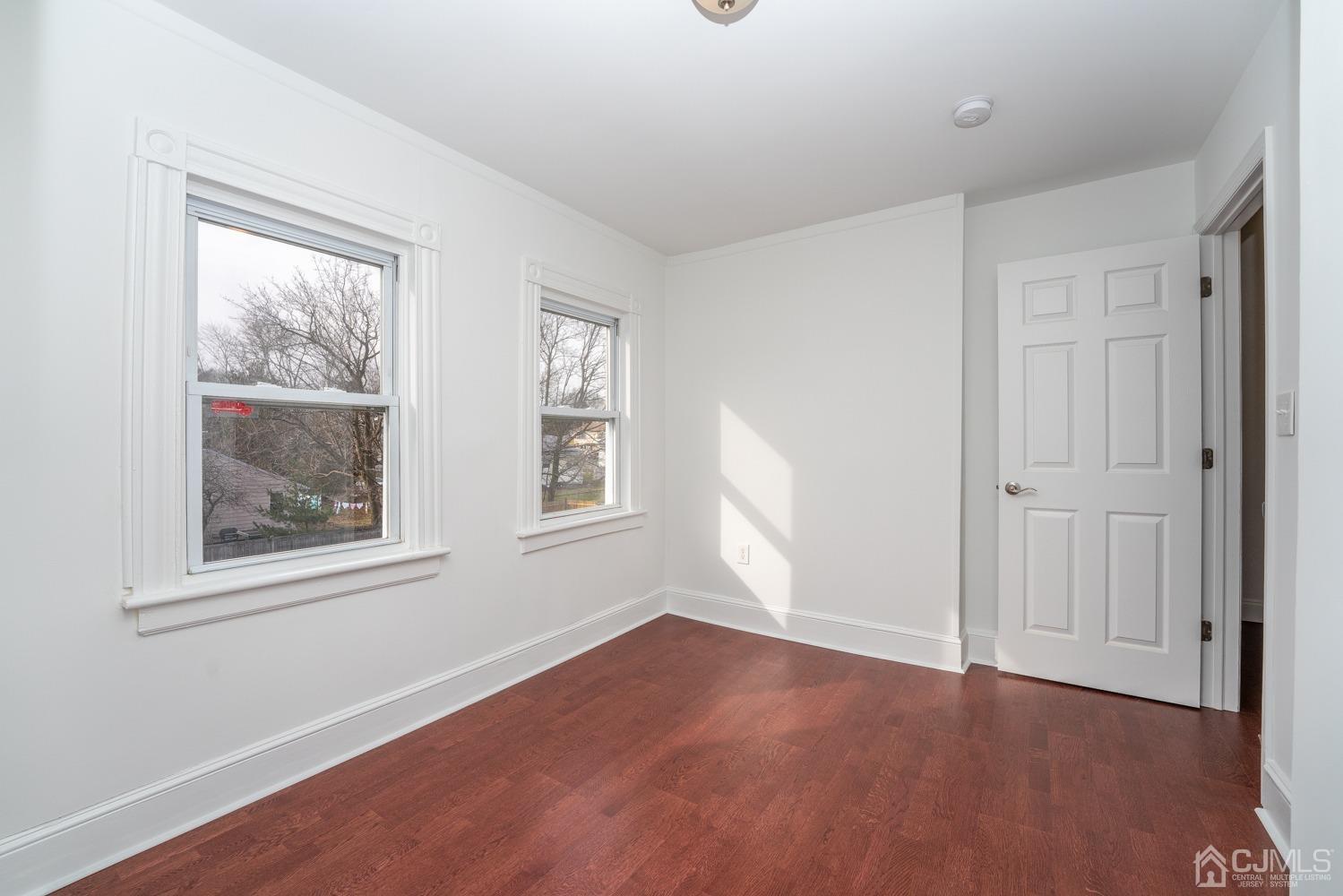 42 Meadow Road Edison, NJ 08817 - Photo 25 of 35 an empty room with wooden floor and windows