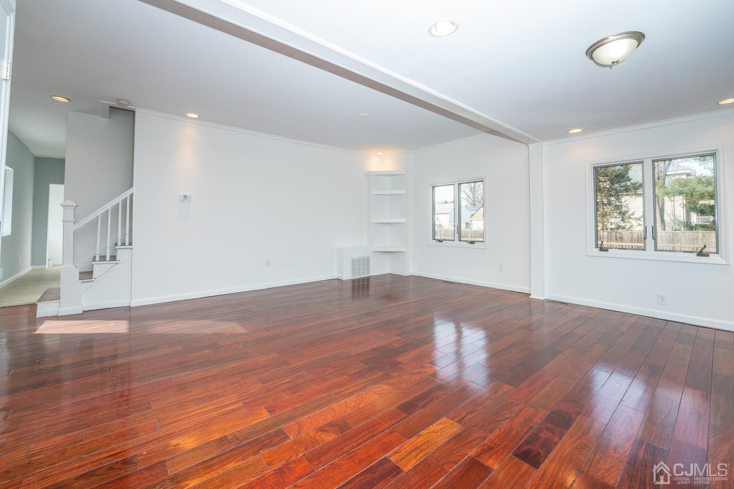 42 Meadow Road Edison, NJ 08817 - Photo 4 of 35 a view of empty room with wooden floor and fan
