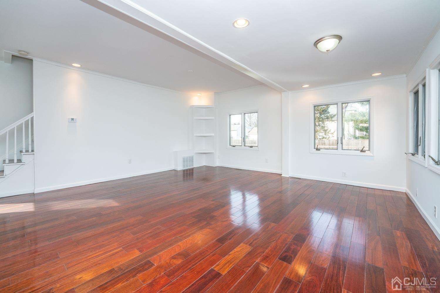42 Meadow Road Edison, NJ 08817 - Photo 5 of 35 an empty room with wooden floor and windows