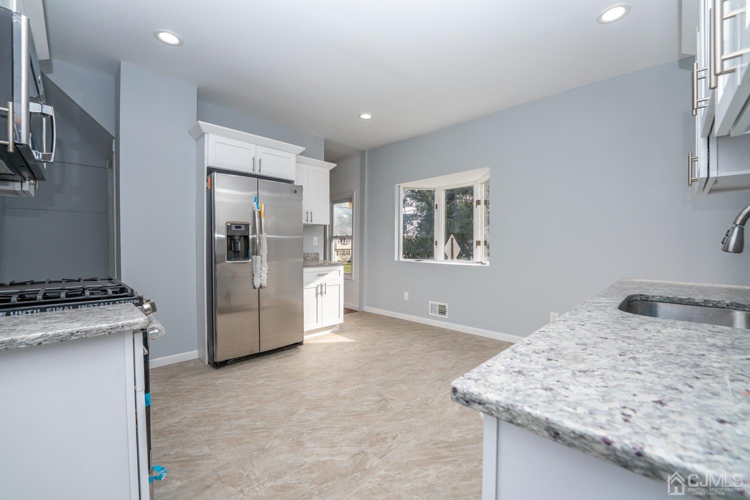 42 Meadow Road Edison, NJ 08817 - Photo 10 of 35 a kitchen with a stove and a refrigerator