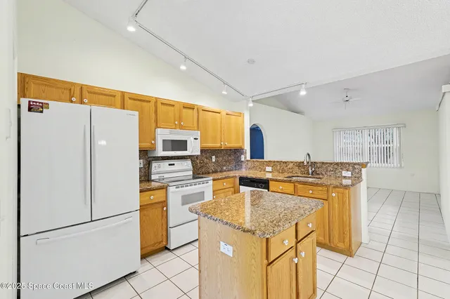 a kitchen with sink a refrigerator and washer