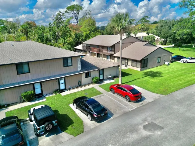 an aerial view of multiple houses with yard