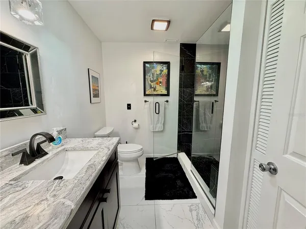 a bathroom with a sink toilet and shower