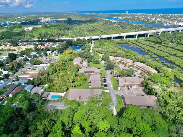 a kitchen with stainless steel appliances granite countertop a refrigerator a stove and a wooden floors