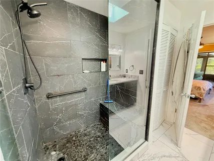 an aerial view of residential houses with outdoor space and trees