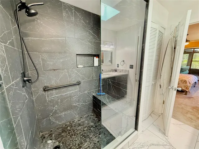 an aerial view of residential houses with outdoor space and trees