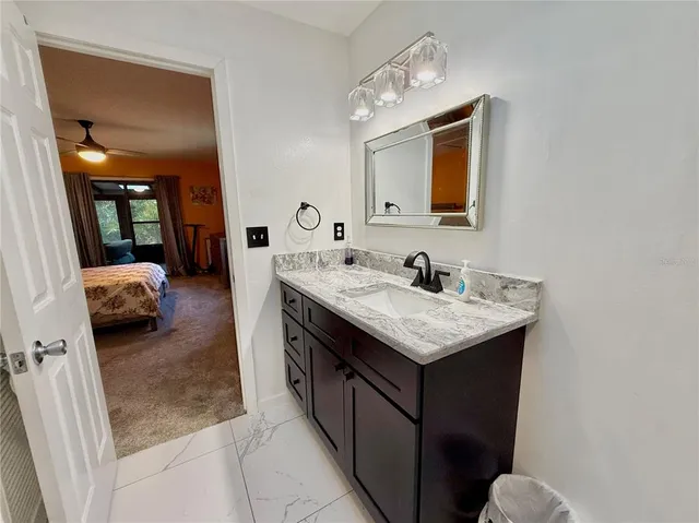 an aerial view of residential houses with outdoor space and trees