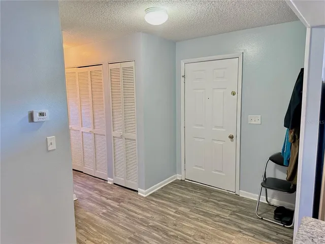 a kitchen with stainless steel appliances granite countertop a refrigerator a stove and a wooden floors