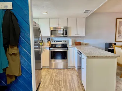 a bedroom with furniture and a flat screen tv